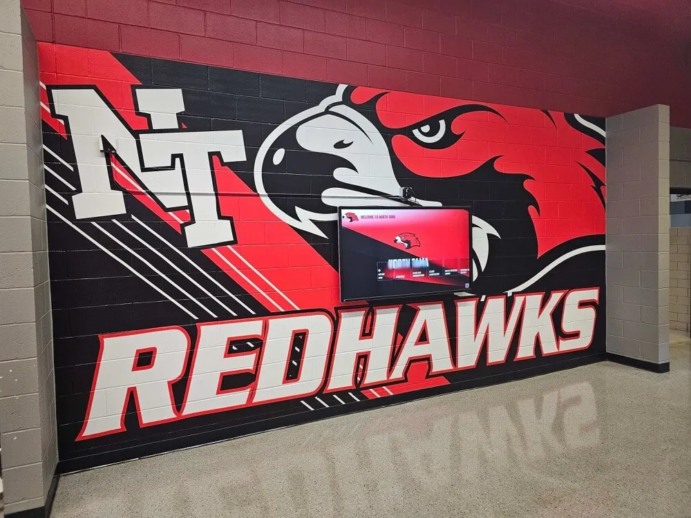 Redhawks school hallway mural with digital screen School hallway mural