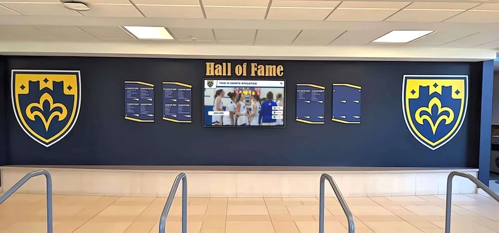 Professional athletic hall of fame wall featuring navy and gold recognition shields Athletic display with shields