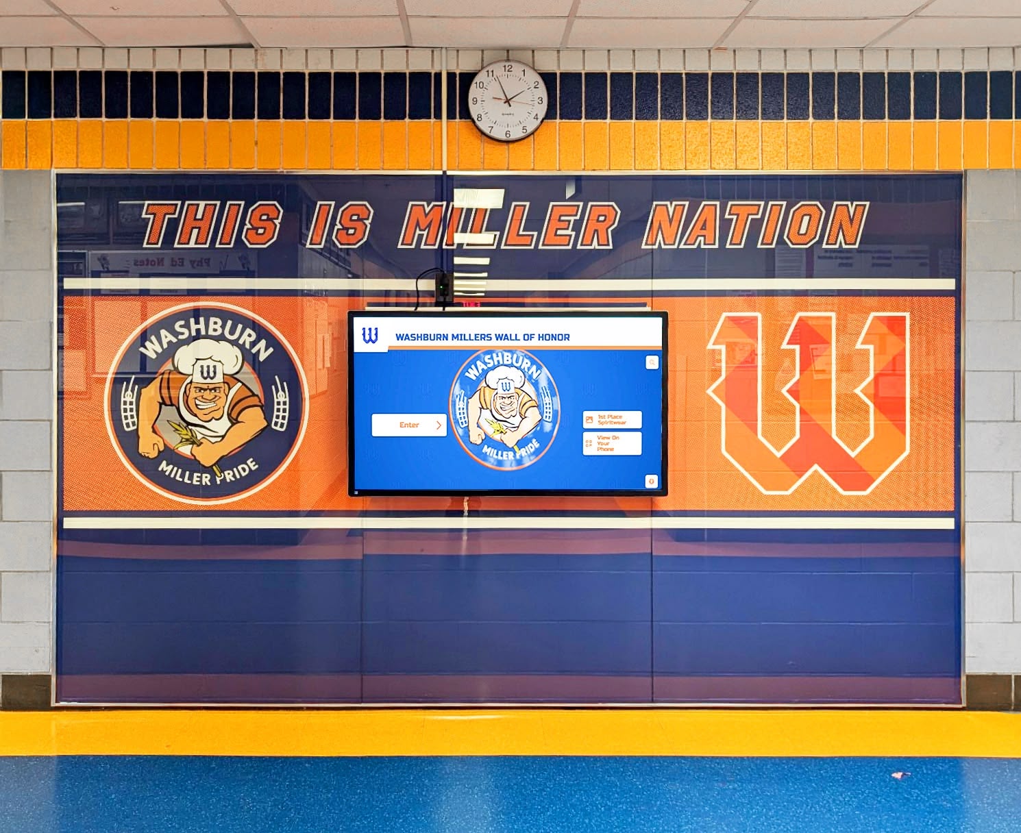 Digital wall of honor display installed in school hallway near entrance area